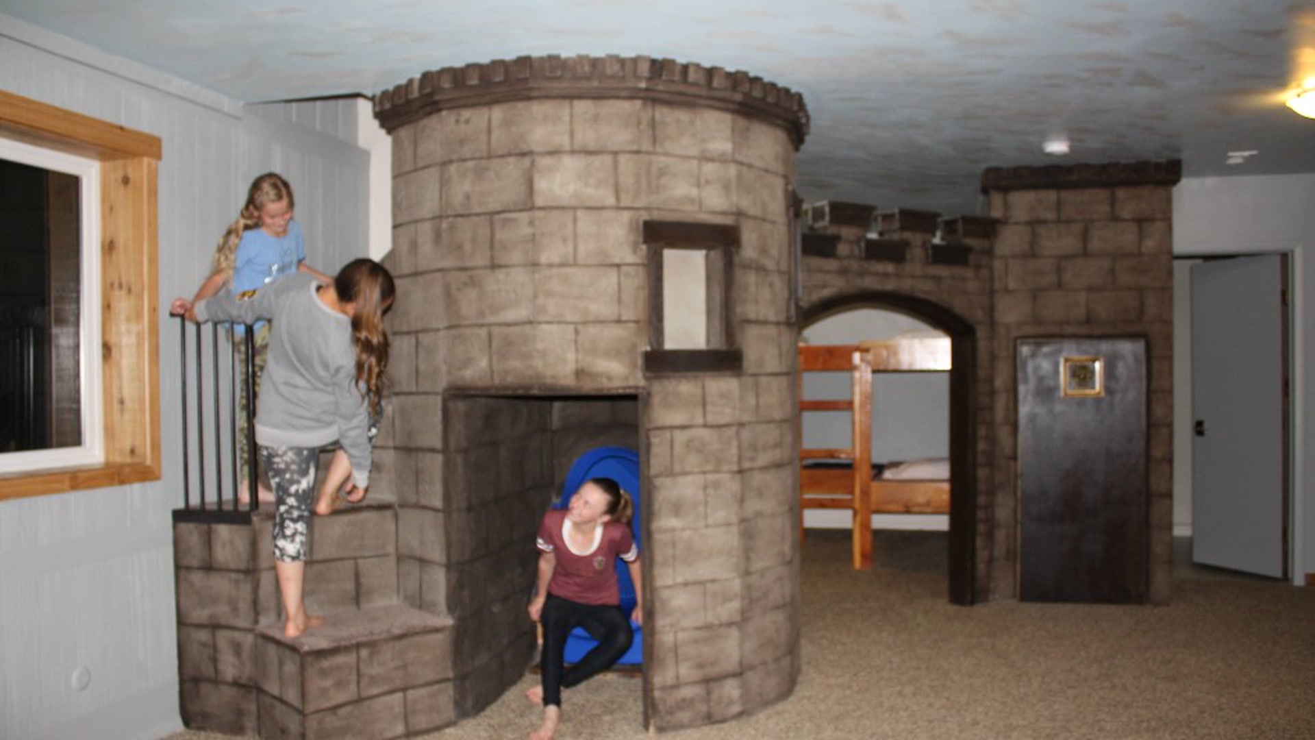 Kids playing on the indoor castle slide at Three Peaks Lodge